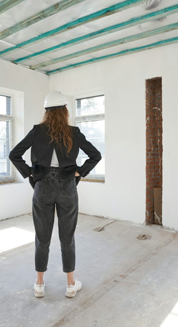 Female construction engineer in room with back to camera